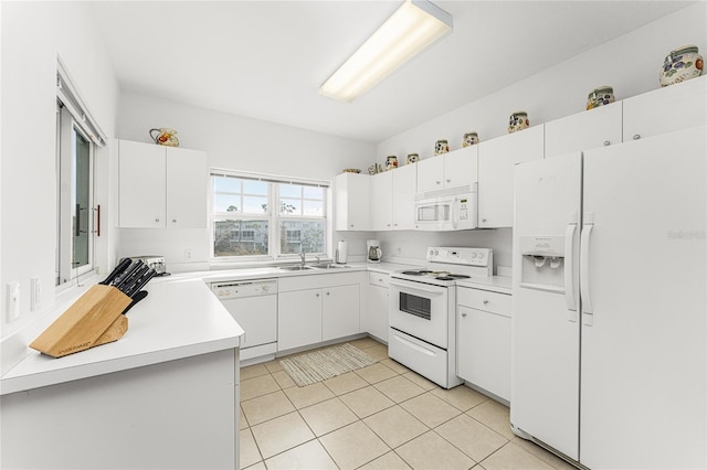 kitchen featuring white appliances, light tile patterned floors, white cabinetry, and sink