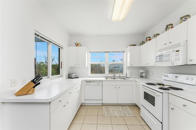 kitchen featuring white cabinets, sink, plenty of natural light, and white appliances