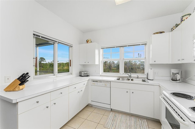 kitchen featuring sink, dishwasher, white cabinetry, and a healthy amount of sunlight