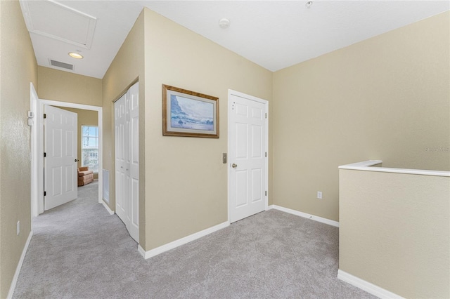 hallway with light colored carpet