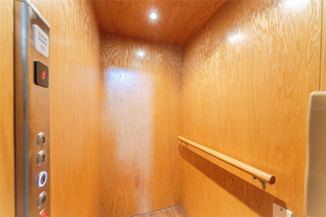 room details with elevator and wood walls