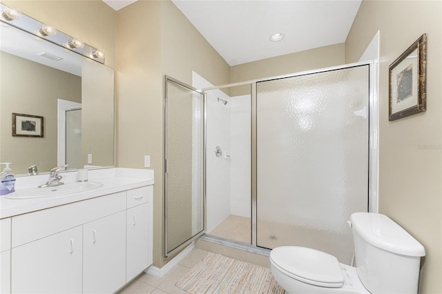 bathroom with vanity, toilet, tile patterned flooring, and a shower with door