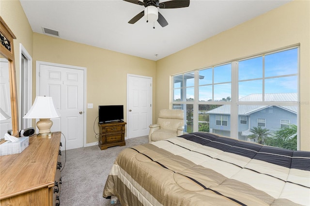 bedroom featuring light colored carpet and ceiling fan