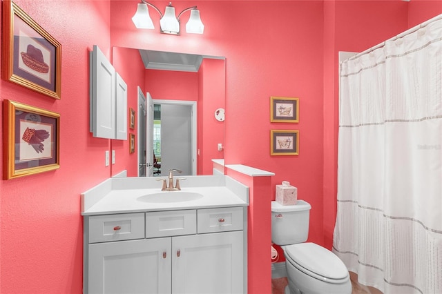 bathroom featuring crown molding, vanity, and toilet