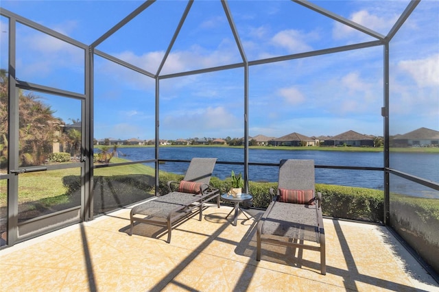 unfurnished sunroom featuring a water view