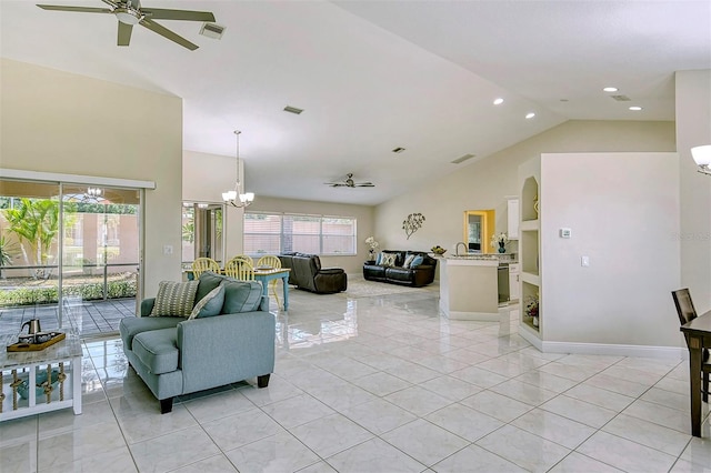 living room featuring vaulted ceiling, light tile patterned floors, and a wealth of natural light