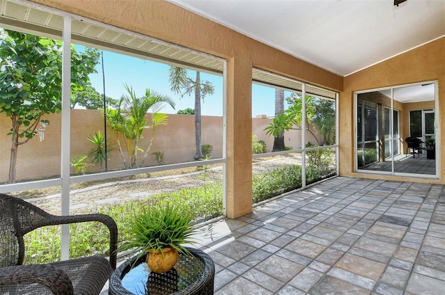 unfurnished sunroom featuring lofted ceiling