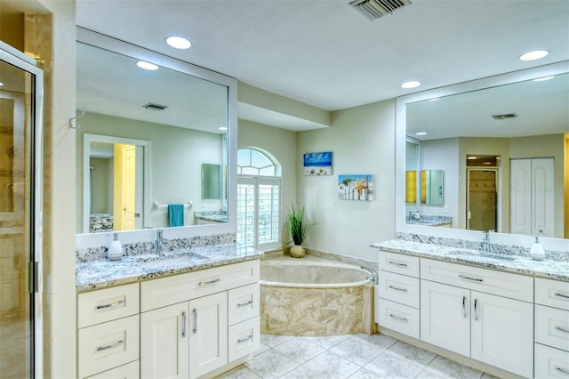 bathroom featuring tile patterned flooring, vanity, and shower with separate bathtub