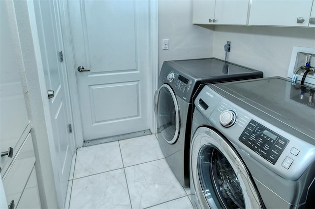 laundry room with cabinets and washer and dryer