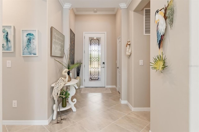 tiled entrance foyer featuring ornamental molding