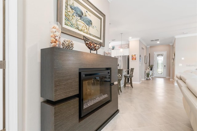 corridor featuring ornamental molding and light tile patterned floors