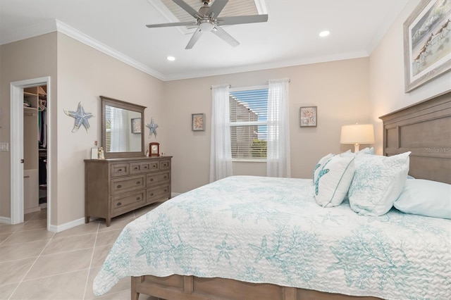 tiled bedroom with a spacious closet, ornamental molding, a closet, and ceiling fan