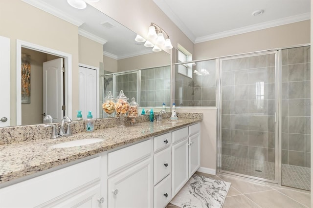 bathroom featuring vanity, a shower with shower door, ornamental molding, and tile patterned flooring