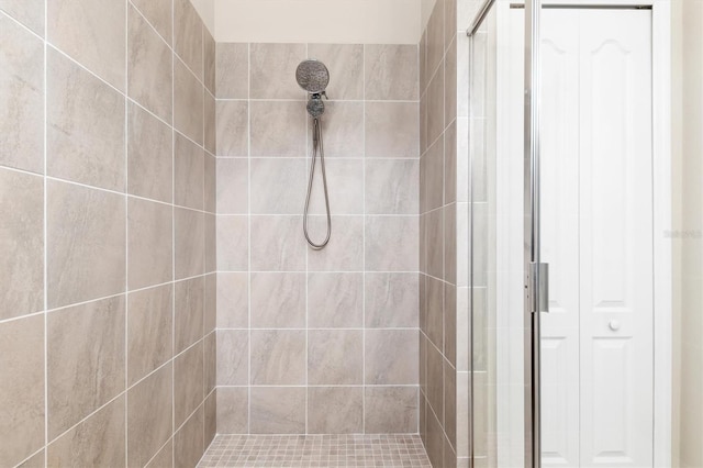 bathroom with a tile shower