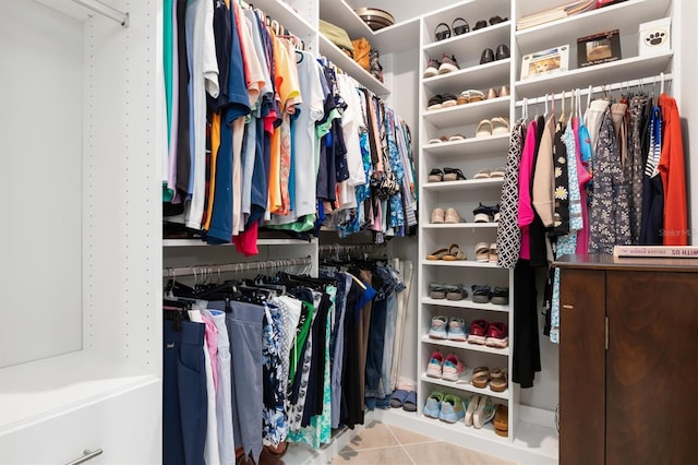 walk in closet with light tile patterned floors