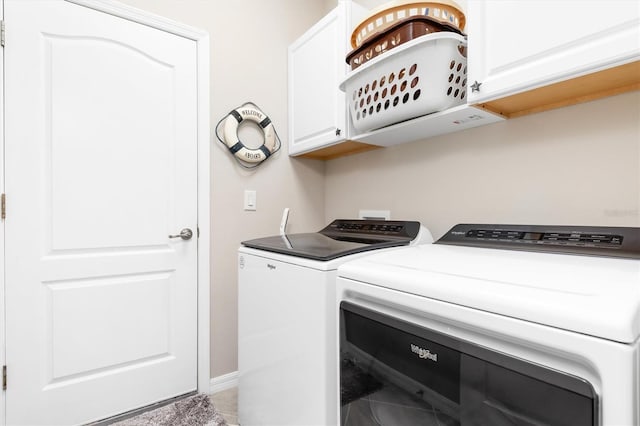 washroom featuring cabinets and independent washer and dryer