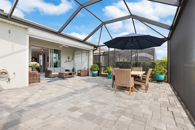 view of patio with ceiling fan, glass enclosure, and an outdoor hangout area