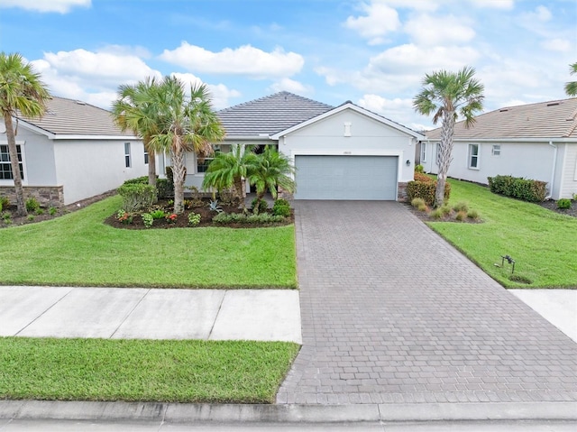 single story home featuring a garage and a front lawn