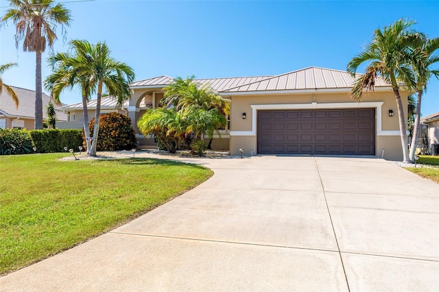 view of front of property featuring a garage and a front yard