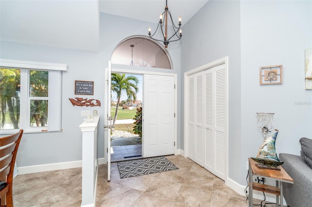 foyer with high vaulted ceiling and a chandelier