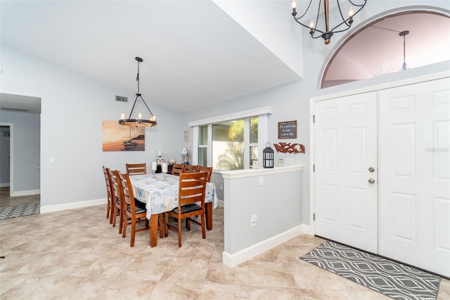 dining room featuring lofted ceiling and a chandelier