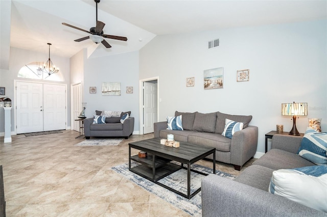 living room featuring ceiling fan with notable chandelier and high vaulted ceiling