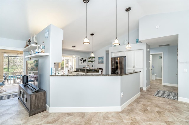 kitchen with pendant lighting, stainless steel refrigerator, white cabinets, kitchen peninsula, and a healthy amount of sunlight