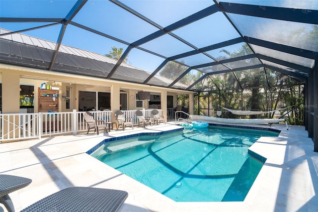 view of pool featuring a patio and glass enclosure