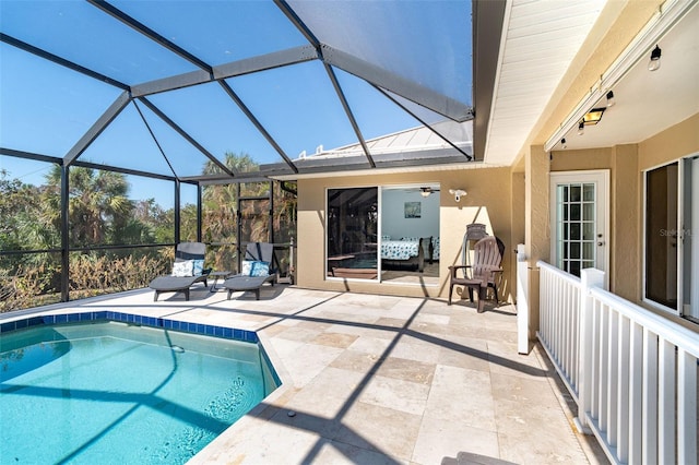 view of pool featuring a patio area and glass enclosure