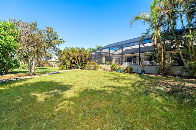 view of yard with glass enclosure