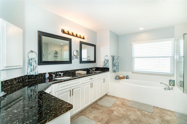 bathroom with vanity and shower with separate bathtub