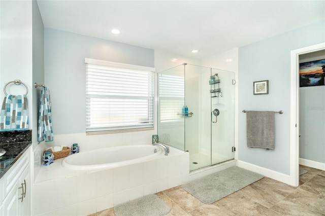 bathroom featuring vanity, tile patterned floors, and plus walk in shower