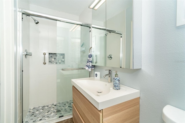 bathroom featuring vanity, toilet, and an enclosed shower