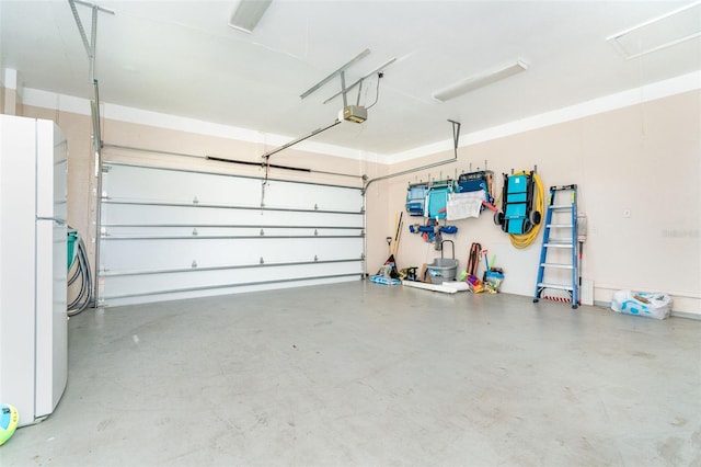 garage with a garage door opener and white fridge