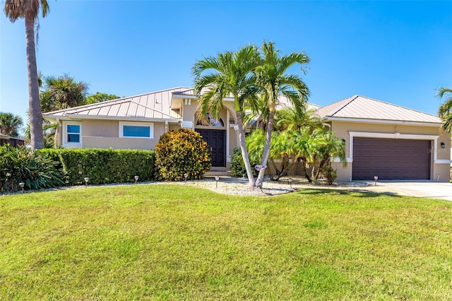 view of front of property with a garage and a front yard