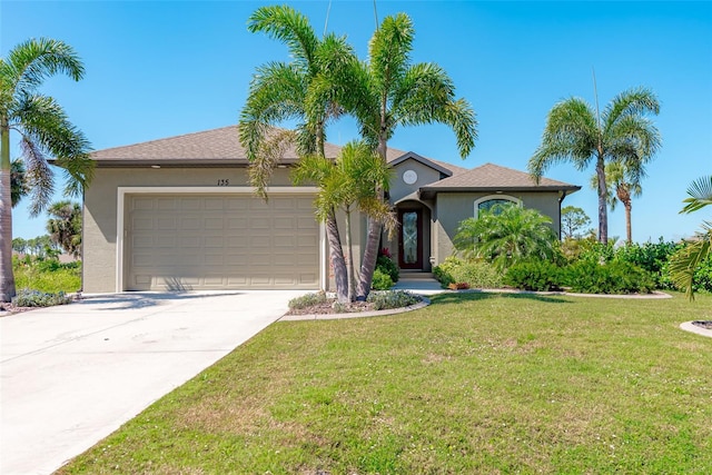 view of front facade with a garage and a front lawn