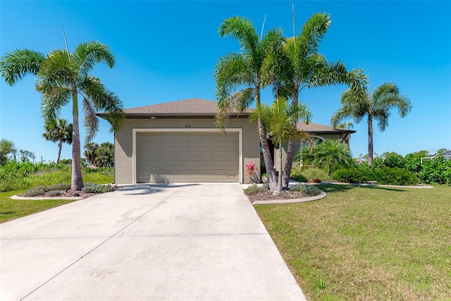 view of front of home with a front yard and a garage