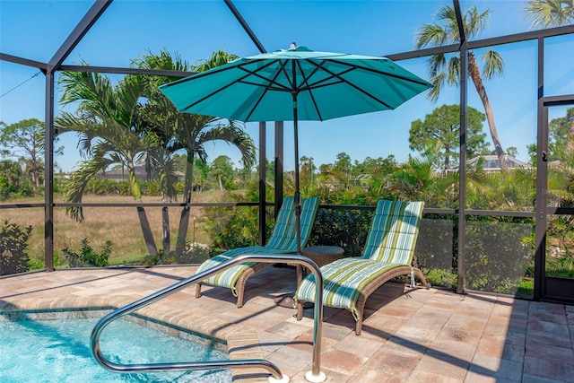 view of pool featuring a patio and glass enclosure