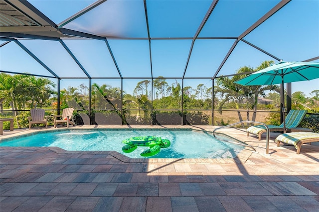 view of swimming pool featuring pool water feature, a patio area, and a lanai