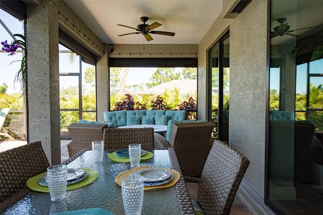 sunroom / solarium featuring ceiling fan