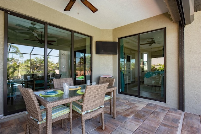 sunroom featuring ceiling fan