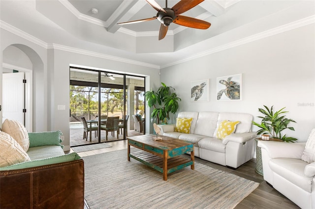 living room with ornamental molding, beamed ceiling, dark hardwood / wood-style flooring, and ceiling fan