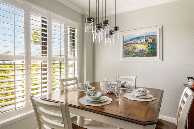 dining space featuring plenty of natural light and ornamental molding