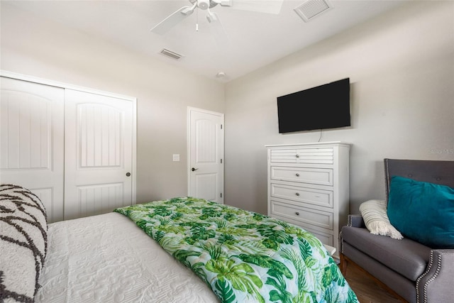 bedroom with ceiling fan, a closet, and wood-type flooring