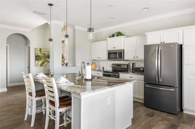 kitchen featuring light stone counters, dark wood-type flooring, sink, white cabinetry, and appliances with stainless steel finishes