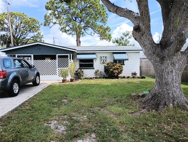 ranch-style house with a front lawn