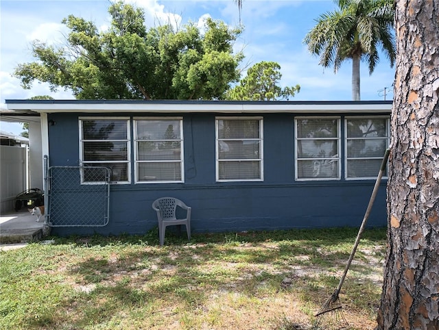 view of side of home with a yard