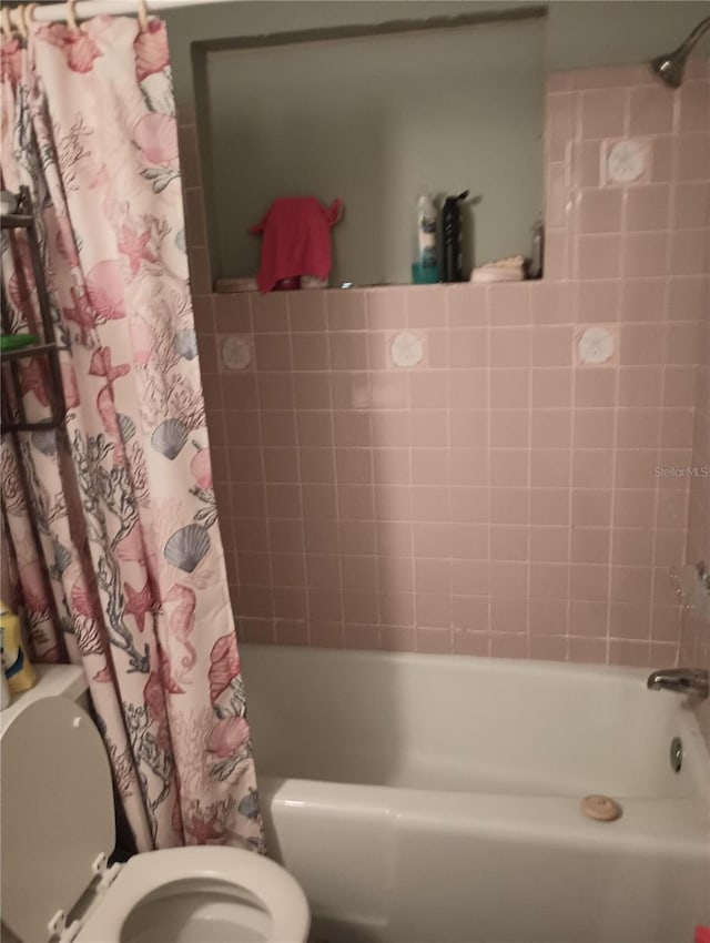 bathroom with toilet and shower / bathtub combination with curtain