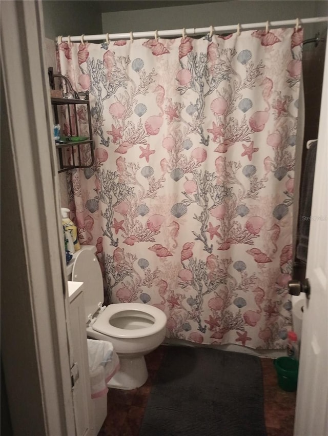 bathroom with toilet and walk in shower