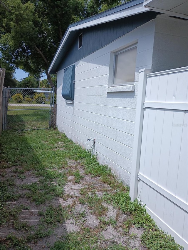 view of side of home with a lawn